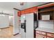 Kitchen area featuring painted cabinets with stainless steel refrigerator and ample shelving at 5069 Cokesbury Rd, Fuquay Varina, NC 27526