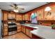 Kitchen area featuring painted wood cabinets, stainless steel appliances, and durable countertops at 5069 Cokesbury Rd, Fuquay Varina, NC 27526