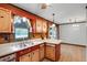 Kitchen featuring unique painted wood cabinets, a double sink, and natural light at 5069 Cokesbury Rd, Fuquay Varina, NC 27526