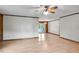 Large living area with light hardwood floors and ceiling fan at 5069 Cokesbury Rd, Fuquay Varina, NC 27526