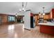 Open floor plan featuring a living room with stone fireplace and a kitchen with appliances at 5069 Cokesbury Rd, Fuquay Varina, NC 27526