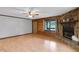 Spacious living room featuring a stone fireplace, wood accents, and large windows at 5069 Cokesbury Rd, Fuquay Varina, NC 27526