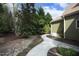 A stone walkway meanders through a meticulously landscaped backyard with lush greenery at 515 Bexley Bluff Ln, Cary, NC 27513