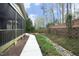 The backyard has a stone walkway winding through the lush landscaping at 515 Bexley Bluff Ln, Cary, NC 27513