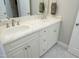 Bathroom with a white double sink vanity, white cabinets, and brushed nickel fixtures at 515 Bexley Bluff Ln, Cary, NC 27513