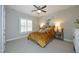 Neutral bedroom featuring a ceiling fan, bedside tables, and a highland cow themed art piece at 515 Bexley Bluff Ln, Cary, NC 27513