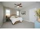 Neutral bedroom featuring a ceiling fan, bedside table, and a cow themed art piece at 515 Bexley Bluff Ln, Cary, NC 27513