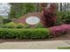 Sign of the Weston Manor community surrounded by colorful flowering shrubs at 515 Bexley Bluff Ln, Cary, NC 27513