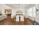Bright dining room featuring hardwood floors, a decorative ceiling, and ample natural light, flowing into the kitchen at 515 Bexley Bluff Ln, Cary, NC 27513