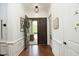 Inviting foyer with hardwood floors, white wainscoting, and an open view of the front door and exterior at 515 Bexley Bluff Ln, Cary, NC 27513