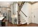 An open hallway features a staircase, modern appliances, and elegant gray cabinetry at 515 Bexley Bluff Ln, Cary, NC 27513