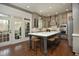 The elegant kitchen has an island with seating, stainless appliances, and a view to the patio at 515 Bexley Bluff Ln, Cary, NC 27513