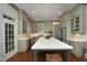 The open-concept kitchen features modern appliances, an island with seating, and a large window at 515 Bexley Bluff Ln, Cary, NC 27513