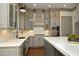 A gourmet kitchen features stainless steel appliances, white countertops, and elegant gray cabinetry at 515 Bexley Bluff Ln, Cary, NC 27513
