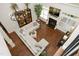 A high angle shows a spacious living room with wood floors, fireplace, built-ins, and large sectional sofa at 515 Bexley Bluff Ln, Cary, NC 27513
