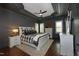 Luxurious main bedroom featuring a tray ceiling, dark walls, and elegant furnishings, creating a serene retreat at 515 Bexley Bluff Ln, Cary, NC 27513
