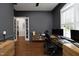 A home office boasts hardwood floors, a large window, and an open doorway at 515 Bexley Bluff Ln, Cary, NC 27513
