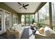 Cozy screened porch with wicker seating and ceiling fan at 515 Bexley Bluff Ln, Cary, NC 27513