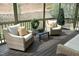 Screened porch featuring wicker seating with neutral cushions and pillows at 515 Bexley Bluff Ln, Cary, NC 27513