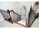 An interior view of a carpeted staircase with wood railing and spindles leading to the second floor at 515 Bexley Bluff Ln, Cary, NC 27513