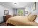 Bright bedroom features wood floors, neutral paint, and a sliding door to the backyard at 518 Morgan Creek Rd, Chapel Hill, NC 27517