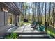 Home's porch with an outdoor seating area and view of wooded area at 518 Morgan Creek Rd, Chapel Hill, NC 27517