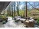 Wood deck features comfortable seating with view of the surrounding wooded area at 518 Morgan Creek Rd, Chapel Hill, NC 27517