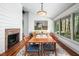Dining room featuring a large window overlooking an outdoor view, a brick fireplace, and hardwood floors at 518 Morgan Creek Rd, Chapel Hill, NC 27517