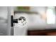 Close-up of a modern glass doorknob reflecting a bright, open interior space at 518 Morgan Creek Rd, Chapel Hill, NC 27517