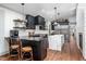 Modern kitchen with black cabinets, white backsplash, stainless steel appliances and marble island at 518 Morgan Creek Rd, Chapel Hill, NC 27517