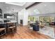 Bright open-concept living space with hardwood floors, skylights, fireplace, and access to outdoor patio at 518 Morgan Creek Rd, Chapel Hill, NC 27517
