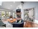 Spacious living room with a brick fireplace, large windows, and comfortable seating at 518 Morgan Creek Rd, Chapel Hill, NC 27517