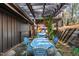 Cozy outdoor seating with pergola, string lights, and vintage decor, perfect for relaxing and entertaining guests at 518 Morgan Creek Rd, Chapel Hill, NC 27517