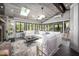 Bright sunroom featuring a white sectional sofa, skylights, and expansive windows at 518 Morgan Creek Rd, Chapel Hill, NC 27517