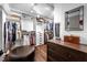 Well-organized walk-in closet with custom shelving, drawers, and a comfortable ottoman at 518 Morgan Creek Rd, Chapel Hill, NC 27517