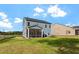 Exterior view of a home with a screened porch and grassy backyard at 5209 Woodlawn Dr, Durham, NC 27703