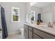 Bright bathroom with dual sinks, granite countertops, and modern fixtures at 5209 Woodlawn Dr, Durham, NC 27703