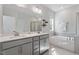 This spacious bathroom boasts double sinks, a soaking tub, and a separate shower, offering a spa-like experience at 5209 Woodlawn Dr, Durham, NC 27703