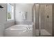 The well-appointed bathroom features a soaking tub and a separate glass shower, combining luxury and functionality at 5209 Woodlawn Dr, Durham, NC 27703