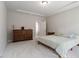 This bedroom offers comfort with soft carpet, a tray ceiling, and a large dresser, creating a peaceful retreat at 5209 Woodlawn Dr, Durham, NC 27703