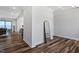 Elegant entryway with hardwood floors, a decorative mirror, and bright natural light, leading to open living spaces at 5209 Woodlawn Dr, Durham, NC 27703