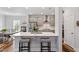 Bright kitchen featuring gray cabinets, a large island with seating and stainless steel appliances at 5209 Woodlawn Dr, Durham, NC 27703