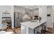 Stylish kitchen featuring gray cabinets, a large island with seating and stainless steel appliances at 5209 Woodlawn Dr, Durham, NC 27703