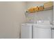 Convenient laundry area with washer, dryer, and storage shelves at 5209 Woodlawn Dr, Durham, NC 27703