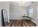 Bright room features stylish hardwood floors, tray ceiling, and ample natural light with space for dining table at 5209 Woodlawn Dr, Durham, NC 27703