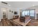 Bright and airy living room featuring hardwood floors, a comfortable sofa, and large windows with serene lighting at 5209 Woodlawn Dr, Durham, NC 27703