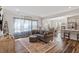 Spacious living room with hardwood floors, a comfortable sofa, and an open layout flowing into the kitchen and dining areas at 5209 Woodlawn Dr, Durham, NC 27703