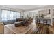 Bright living room featuring a modern kitchen with stainless steel appliances and a beautiful hardwood floor at 5209 Woodlawn Dr, Durham, NC 27703