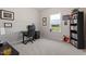 Functional office space with a work desk, computer, and large window offering great light and green views at 5209 Woodlawn Dr, Durham, NC 27703