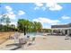 Recreational pool area featuring lounge chairs, tables with umbrellas, and play structures at 5209 Woodlawn Dr, Durham, NC 27703